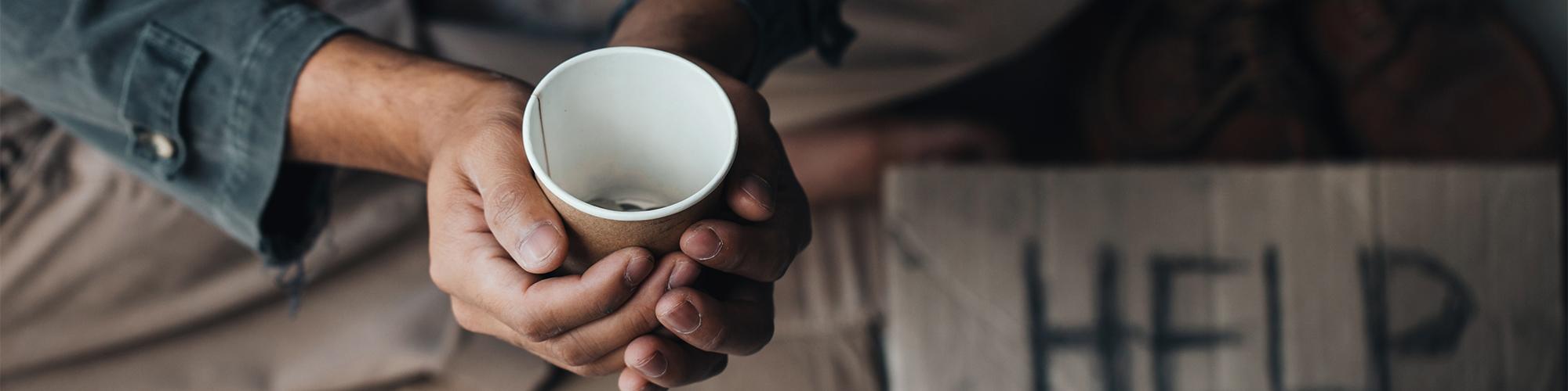 Man holding cup on street