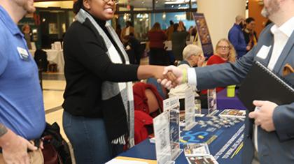 Individuals learning about the OnBoard program and talking with local nonprofits